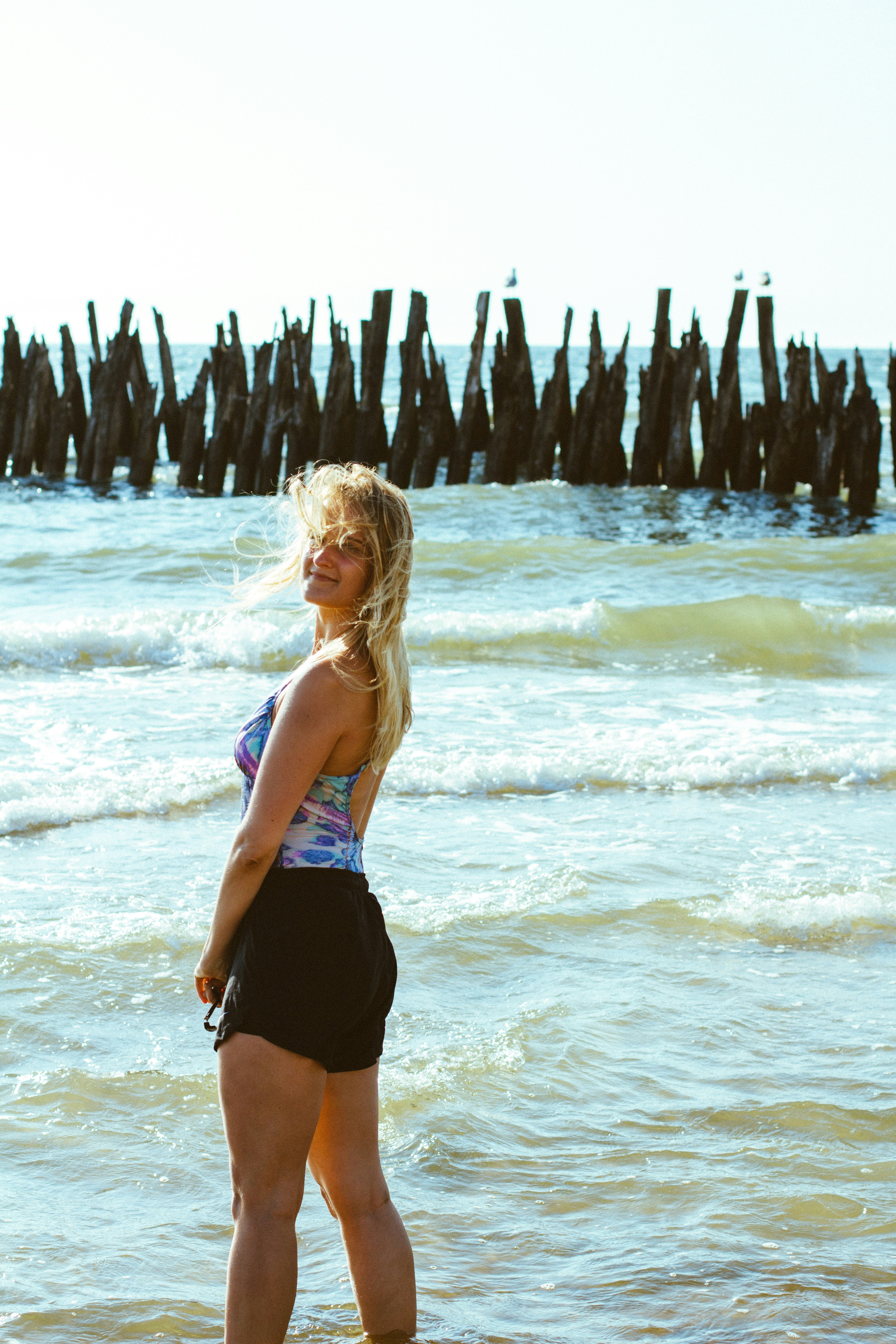 Woman in blue and black bikini standing on beach during daytime photo ...