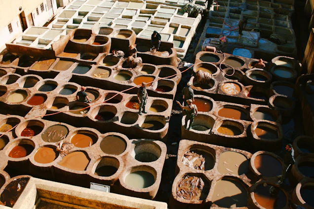 A professional leather inspection process in a modern factory with skilled workers examining hides carefully.