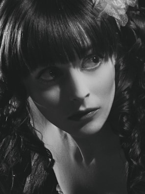 Artistic portrait of a woman with colorful shadows and creative composition.