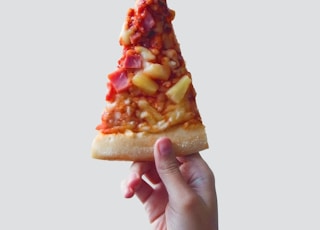 person holding sliced pizza