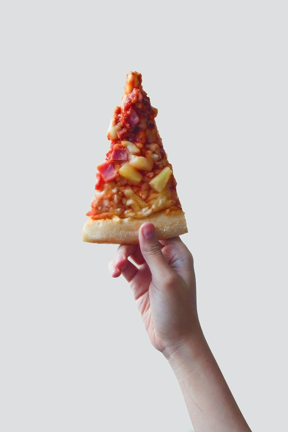 person holding sliced pizza