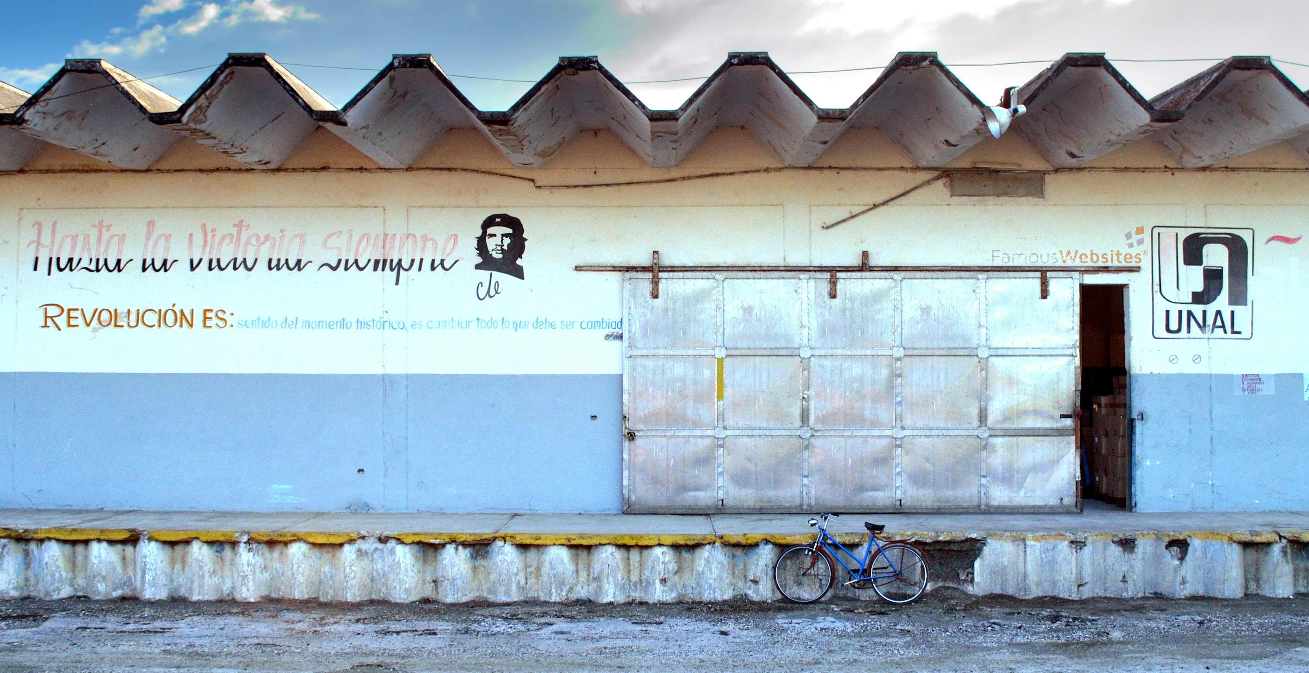 blue bicycle parked near white house