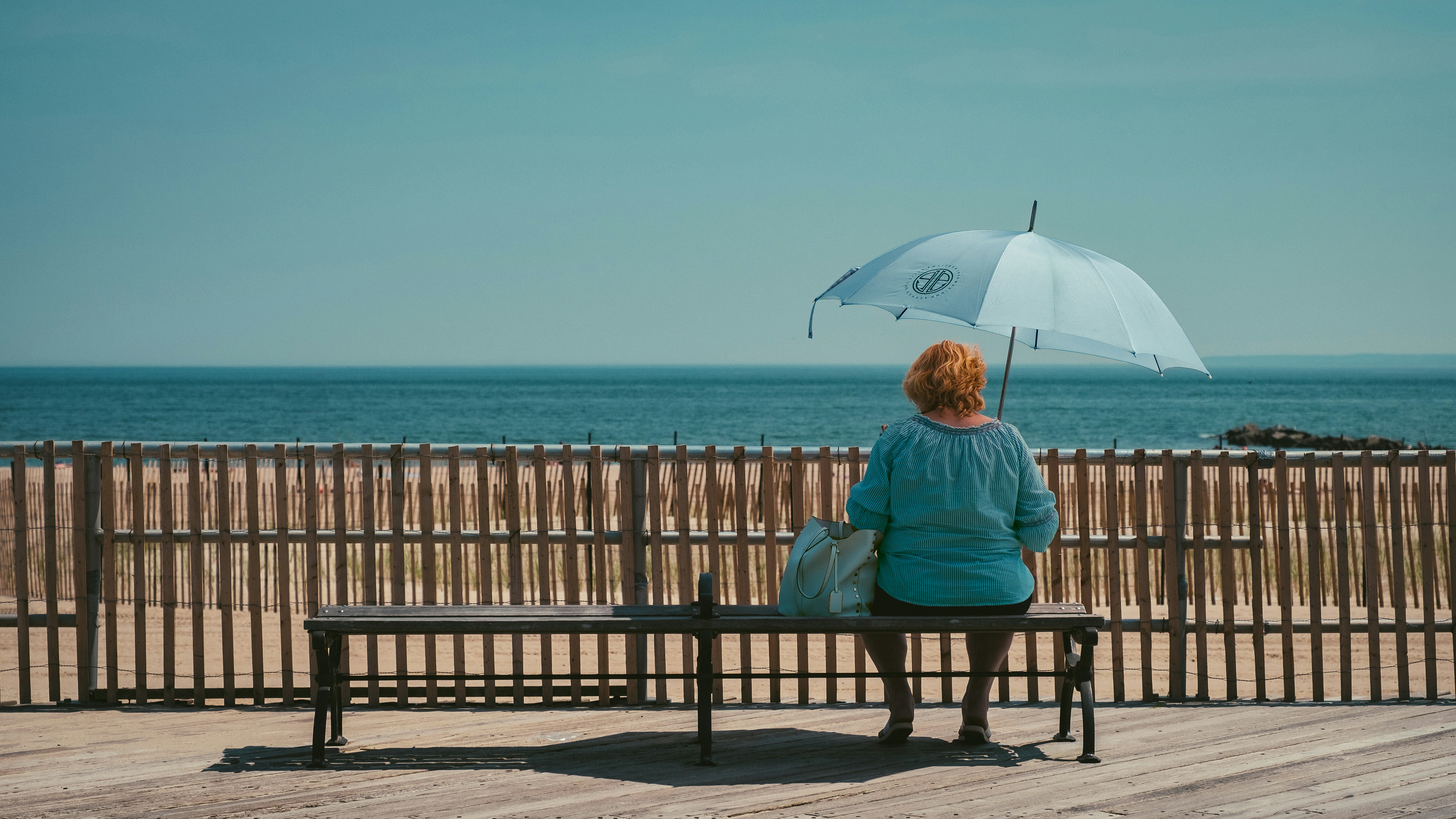 woman wearing blue top sitting on chair