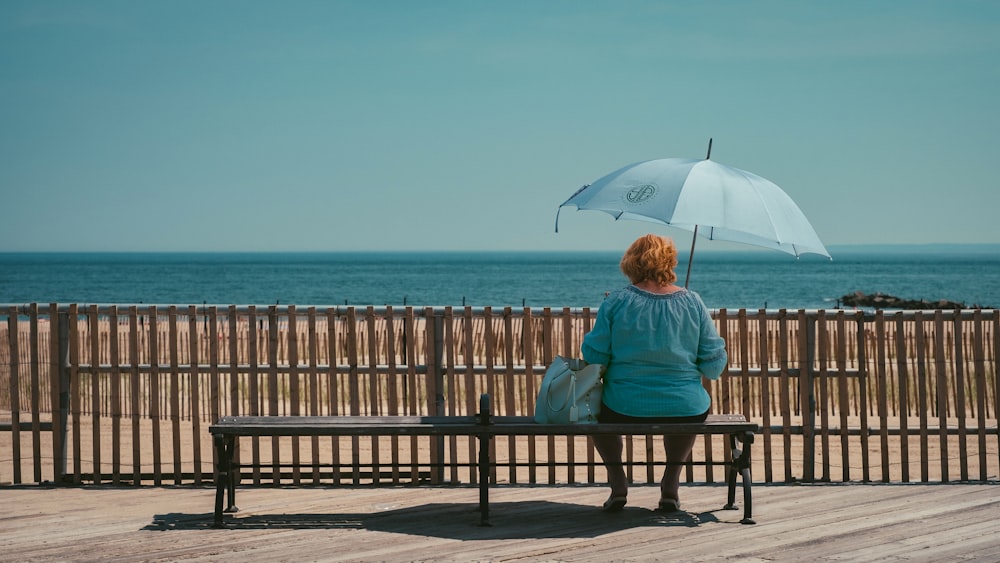 woman wearing blue top sitting on chair