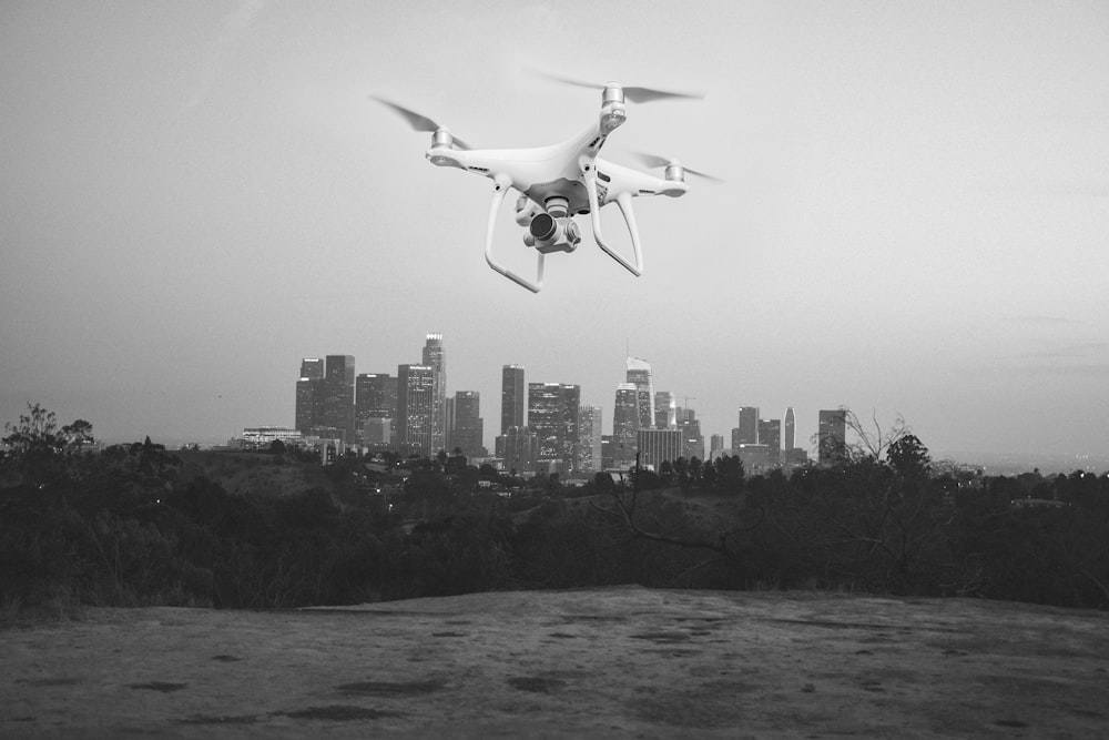 grayscale photography of drone near body of water
