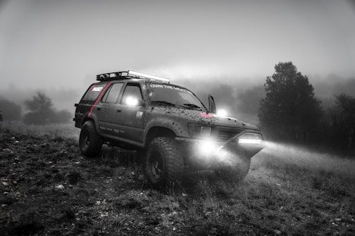 Powerful fog lights cutting through a misty road, mounted on a rugged off-road vehicle.