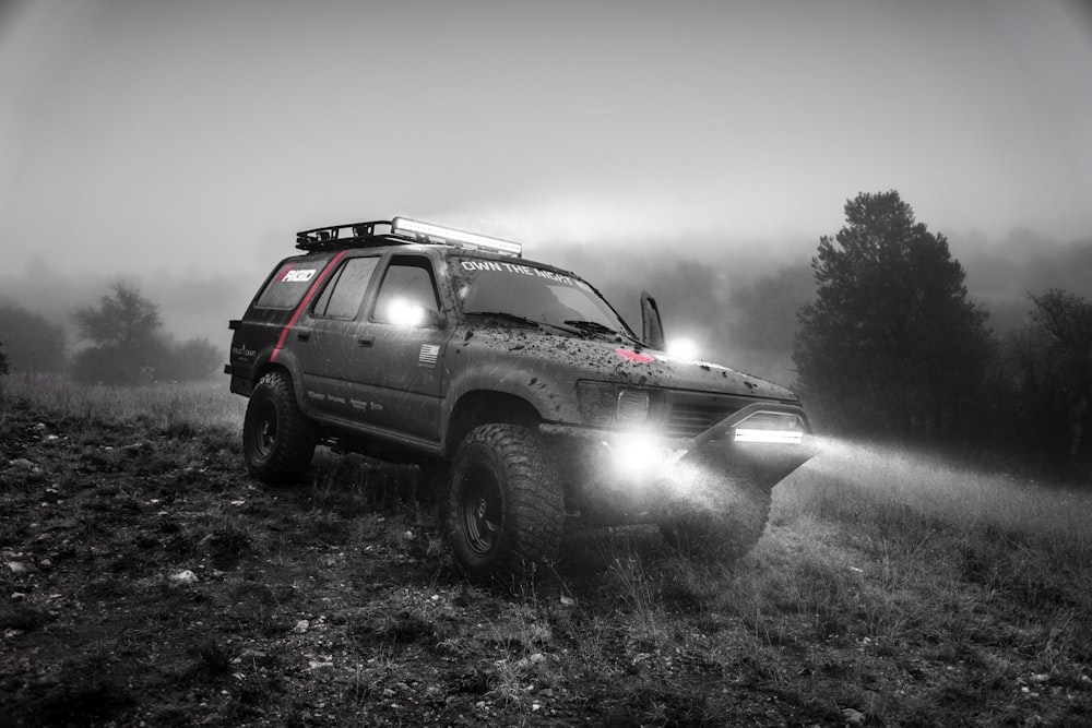 grayscale photography of SUV near forest