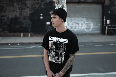 Street-style shot of a young person confidently rocking a Mono Joe tee with urban graffiti in the background.
