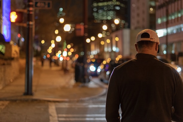 Urban street scene featuring a person wearing a charcoal exa cap with electric blue highlights.