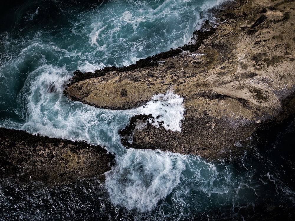 bird's eye view photography of a land near water