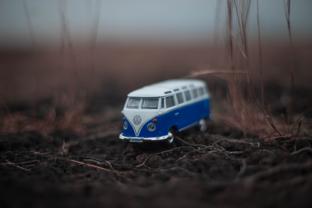 white and blue classic Volkswagen T1 die-cast miniature on ground