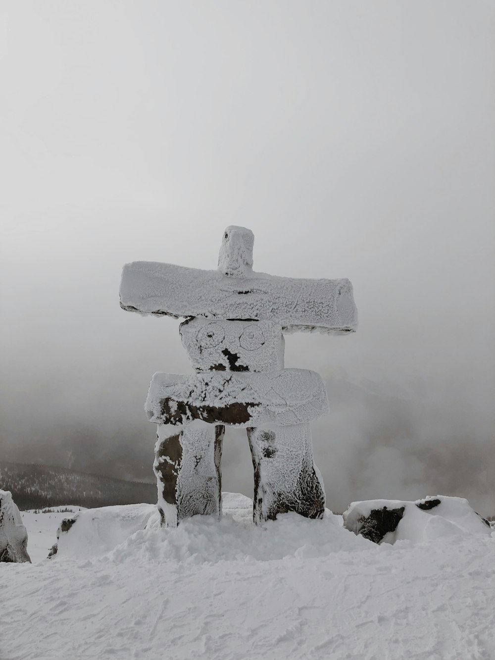 brown cross decor covered with snow