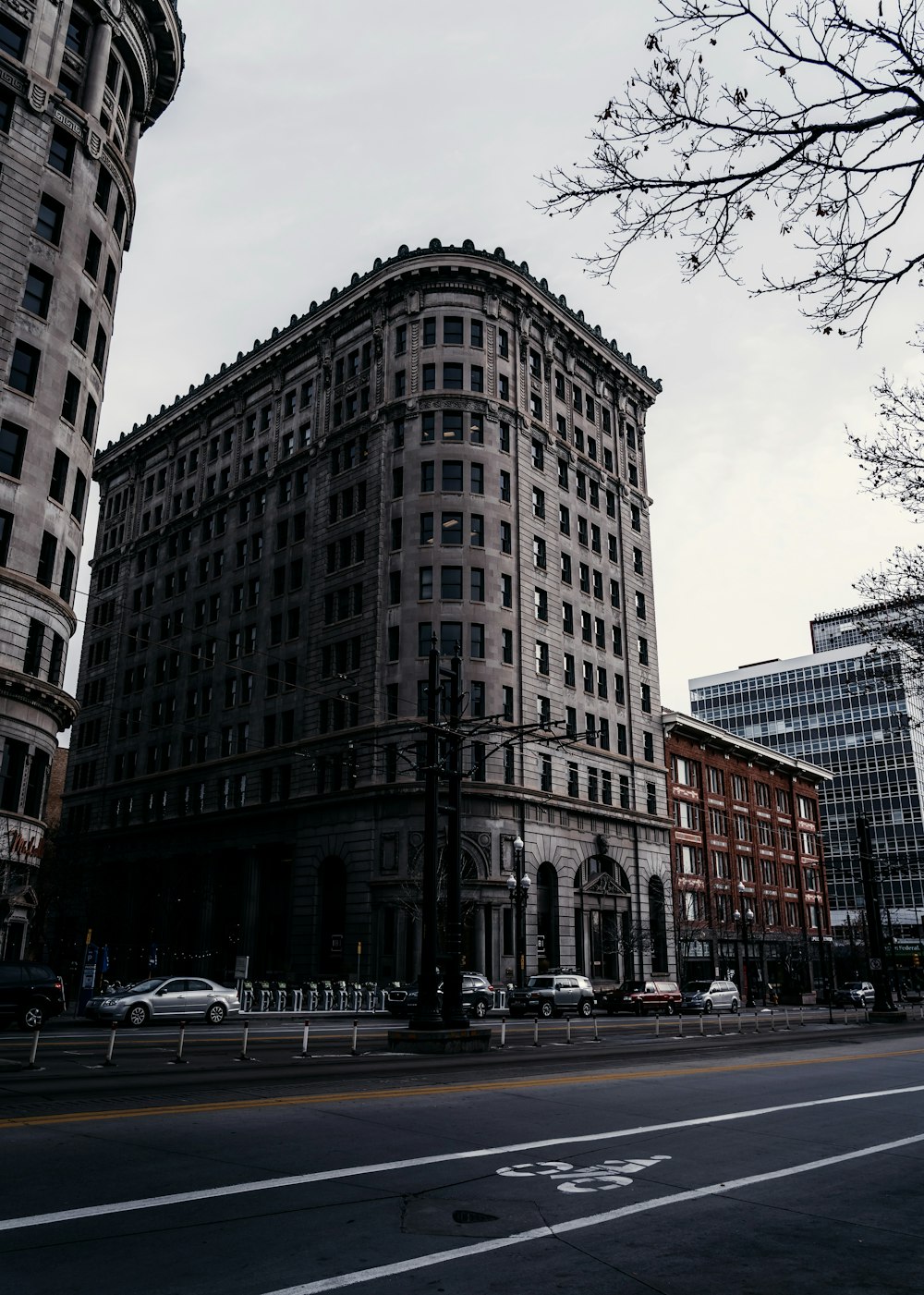 vehicles passing high rise building