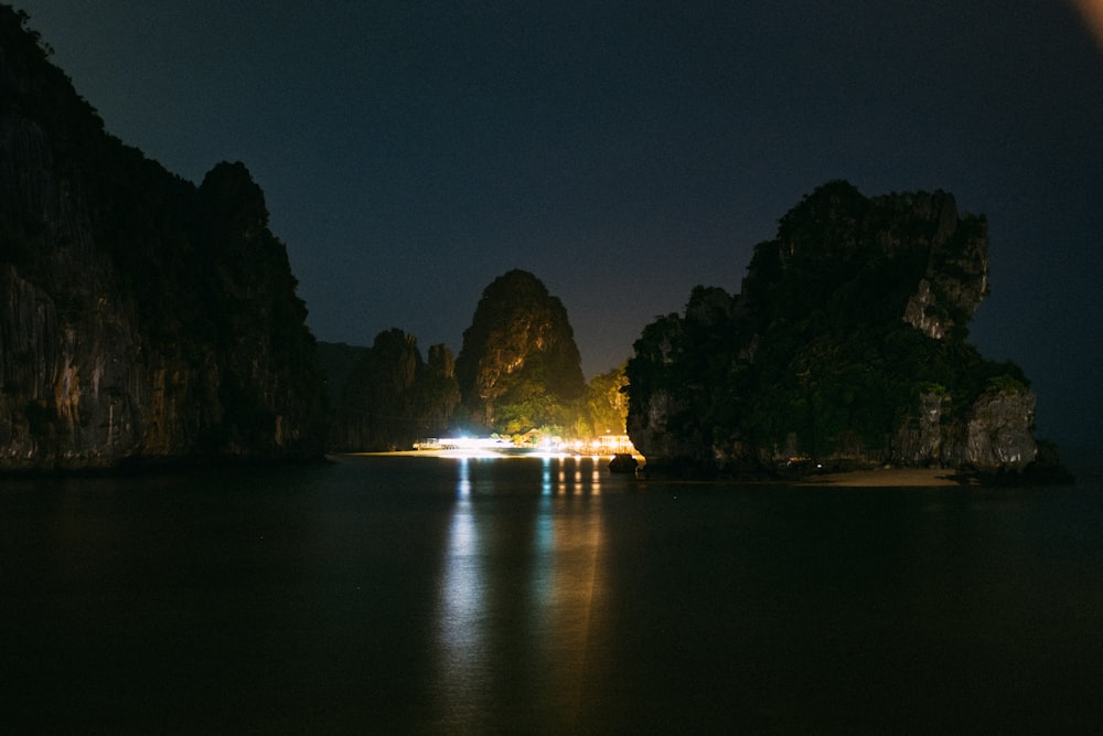 rock formation under gray sky at nighttime