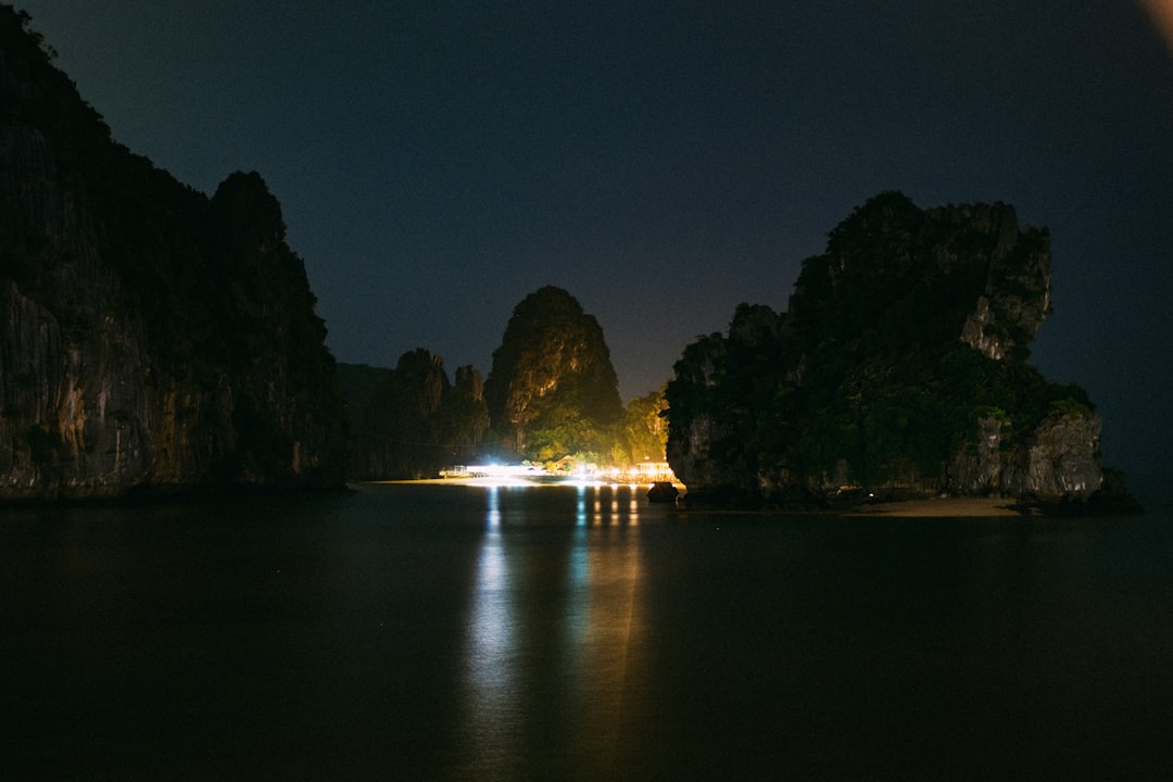 rock formation under gray sky at nighttime,