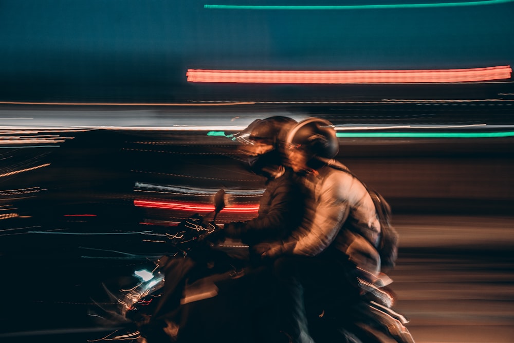 time lapse photography of two people riding motorcycle