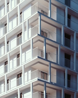 low-angle photography of white concrete high-rise building during daytime