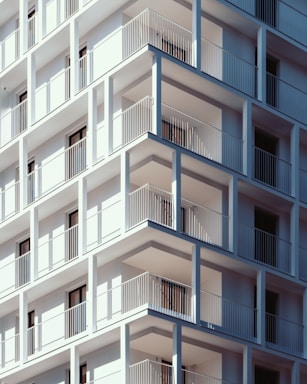 low-angle photography of white concrete high-rise building during daytime