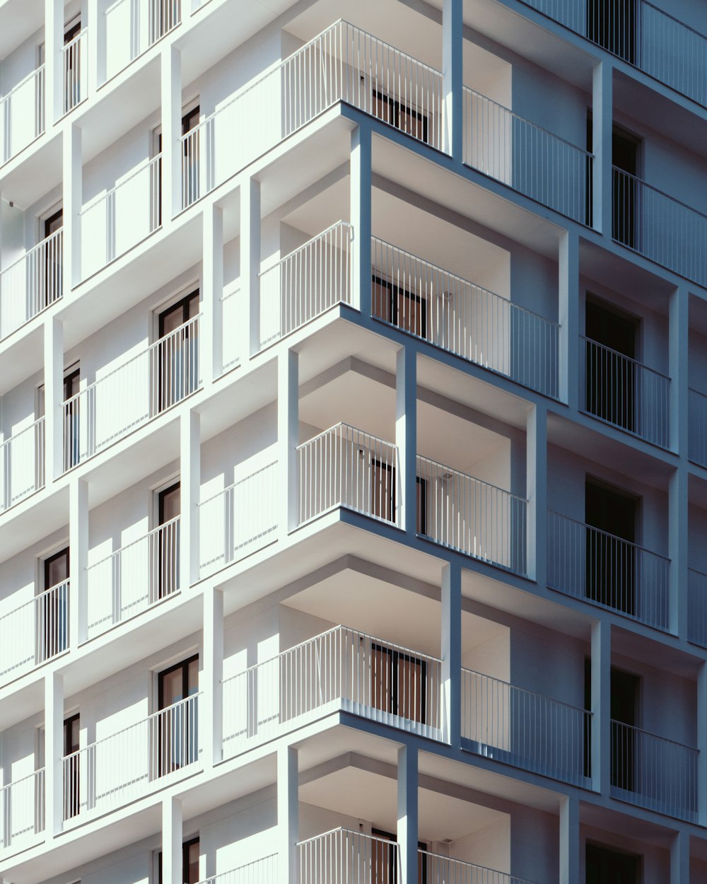 low-angle photography of white concrete high-rise building during daytime