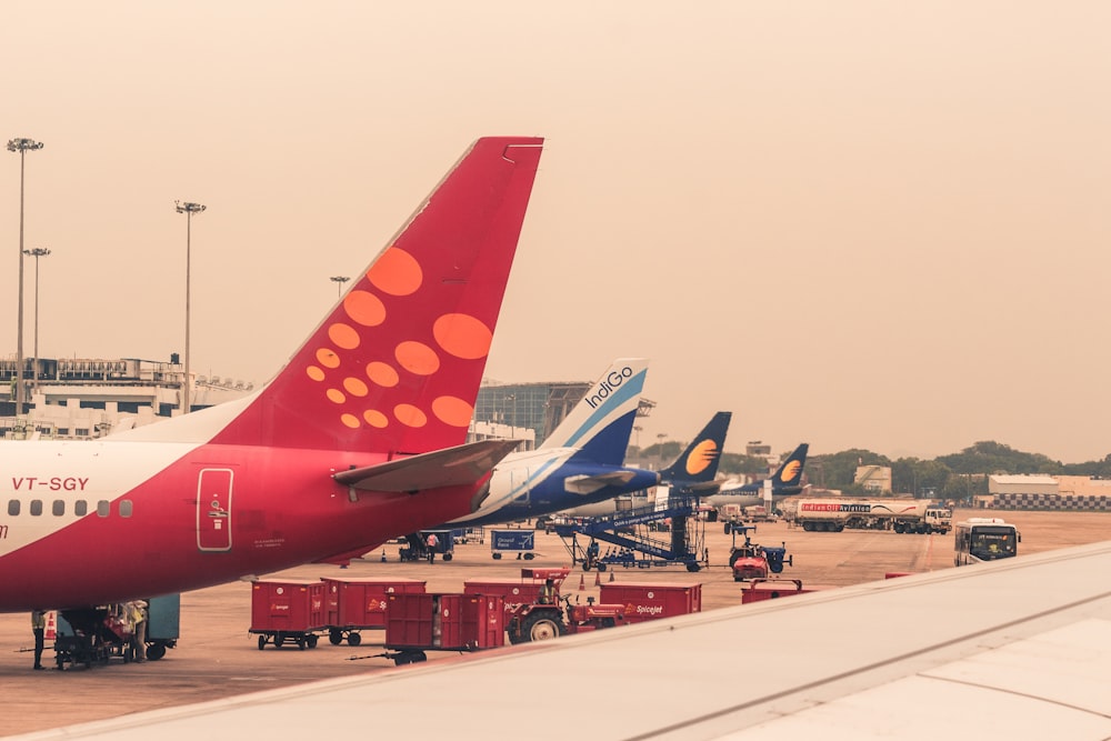 four airliners parked beside airport
