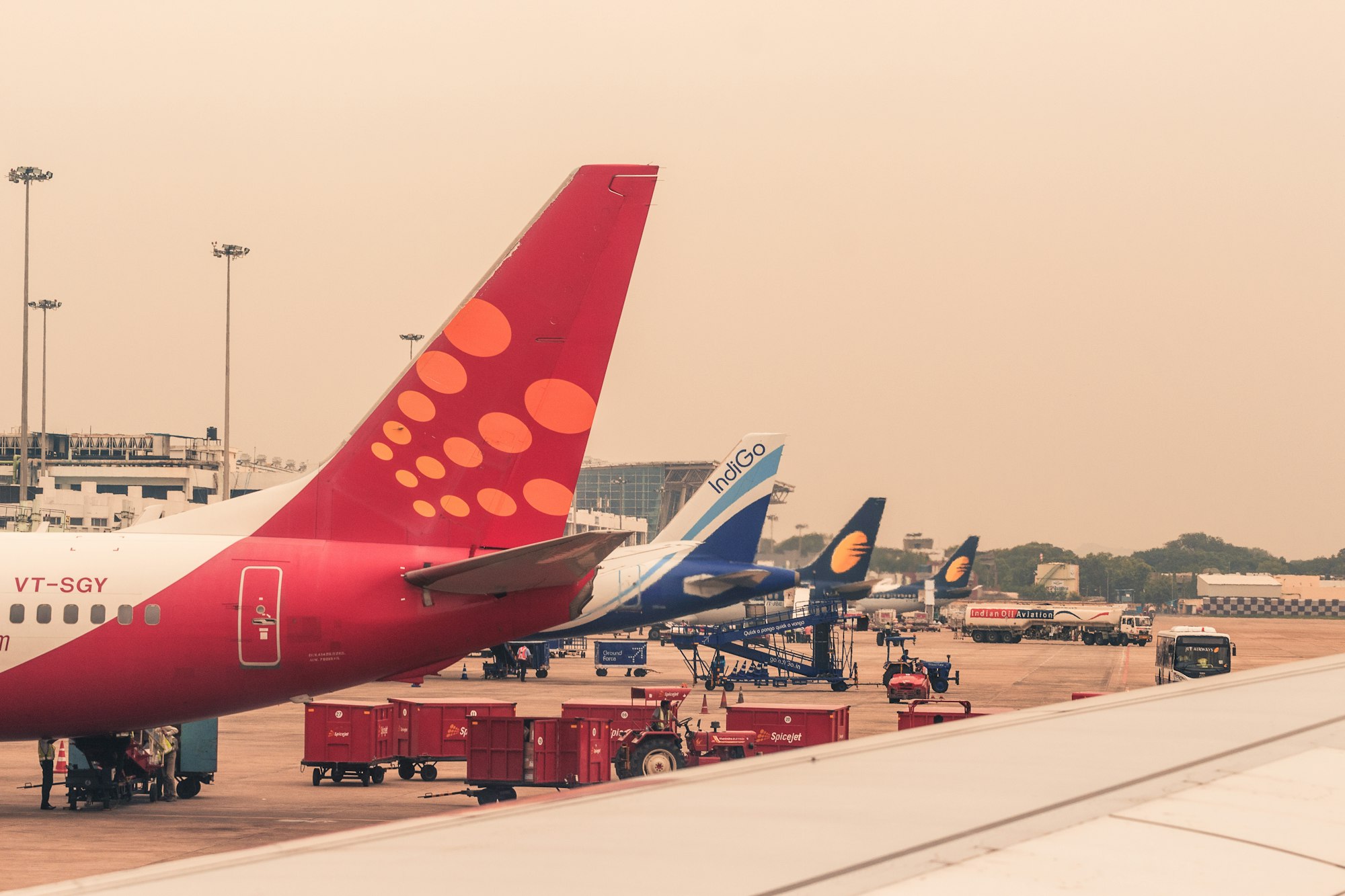 four airliners parked beside airport