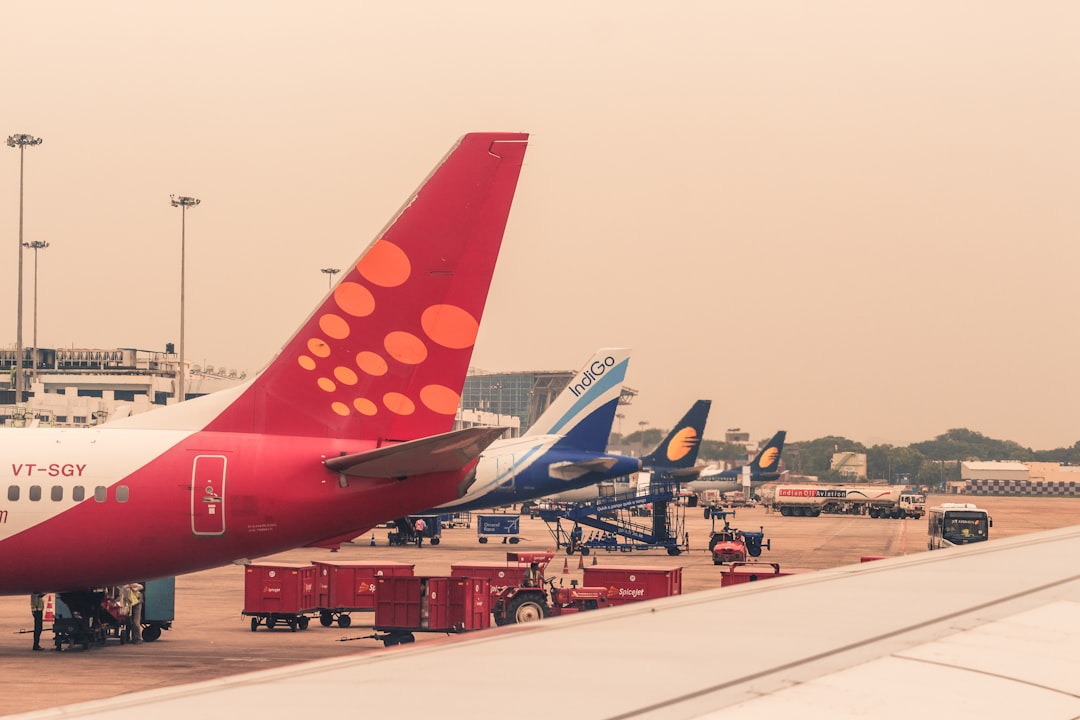 four airliners parked beside airport,