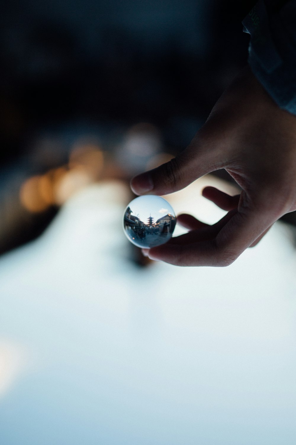 person holding clear glass mirror