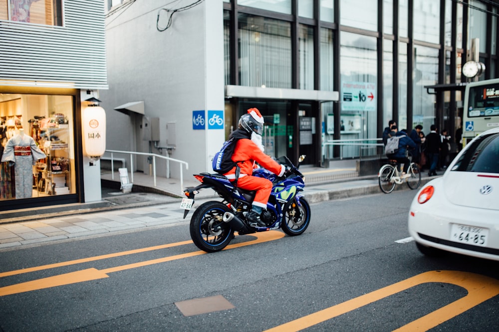 man in blue Yamaha sports bike in street