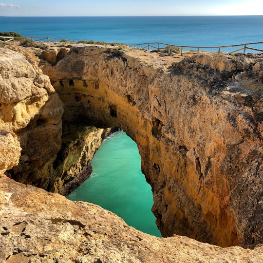 brown rock formation during daytime in Faro Portugal