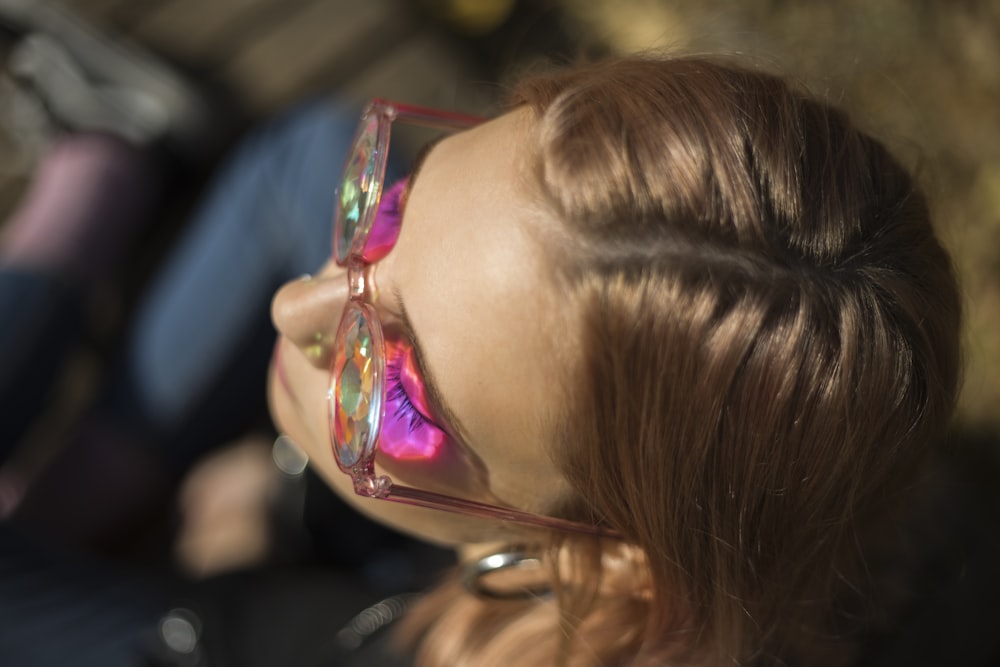 woman wearing pink sunglasses