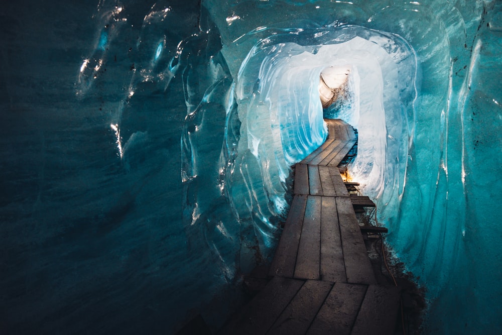 a person is walking through a tunnel in the ice