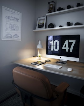 A neat office desk with a computer screen showing a well-organized digital document management system.
