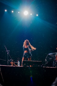 An artist performing on stage with dynamic dance moves.