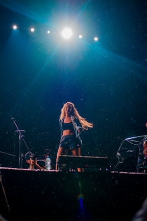 Energetic youth dancer performing under colorful stage lights.