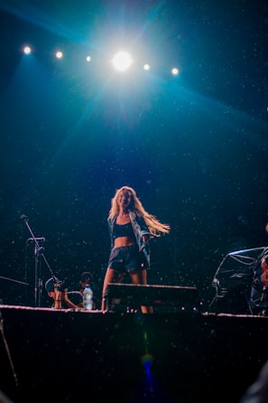 An energetic moment of a performer dancing freely in front of her webcam.