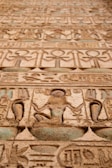 Close-up of an ancient temple’s intricate hieroglyphics carved into sandstone walls.