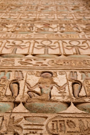 Close-up of an ancient temple’s intricate hieroglyphics carved into sandstone walls.