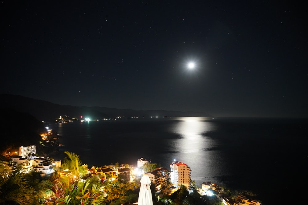 cities at night time near body of water