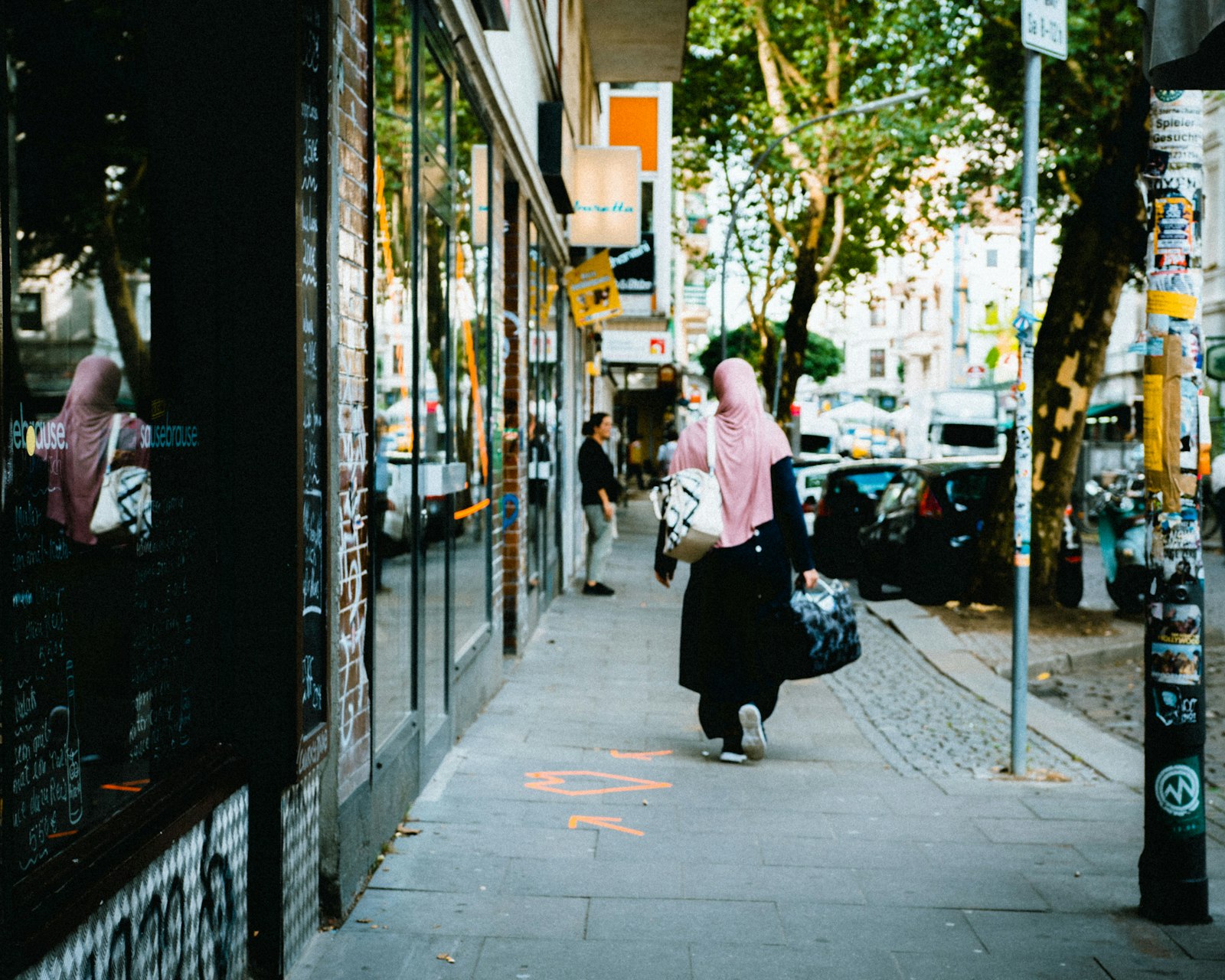 Sony a6300 + DT 0mm F0 SAM sample photo. Woman walking on street photography