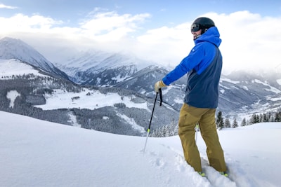 man in skier on snow covered field at daytimee