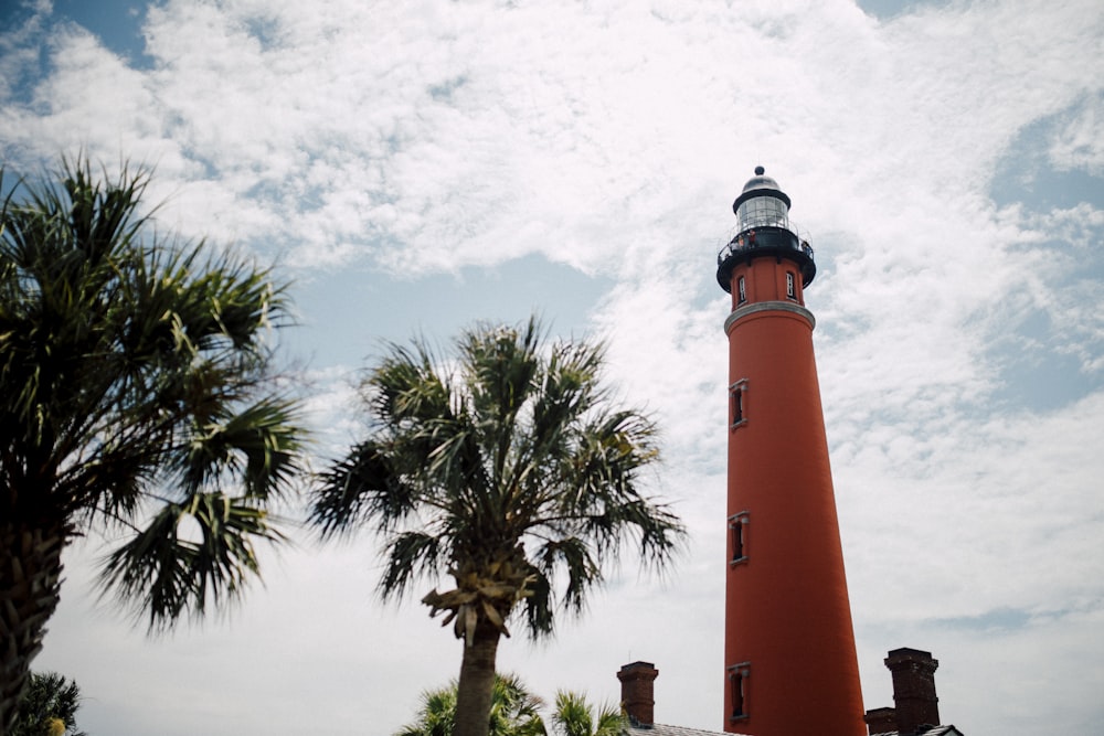 red lighthouse under blue sky