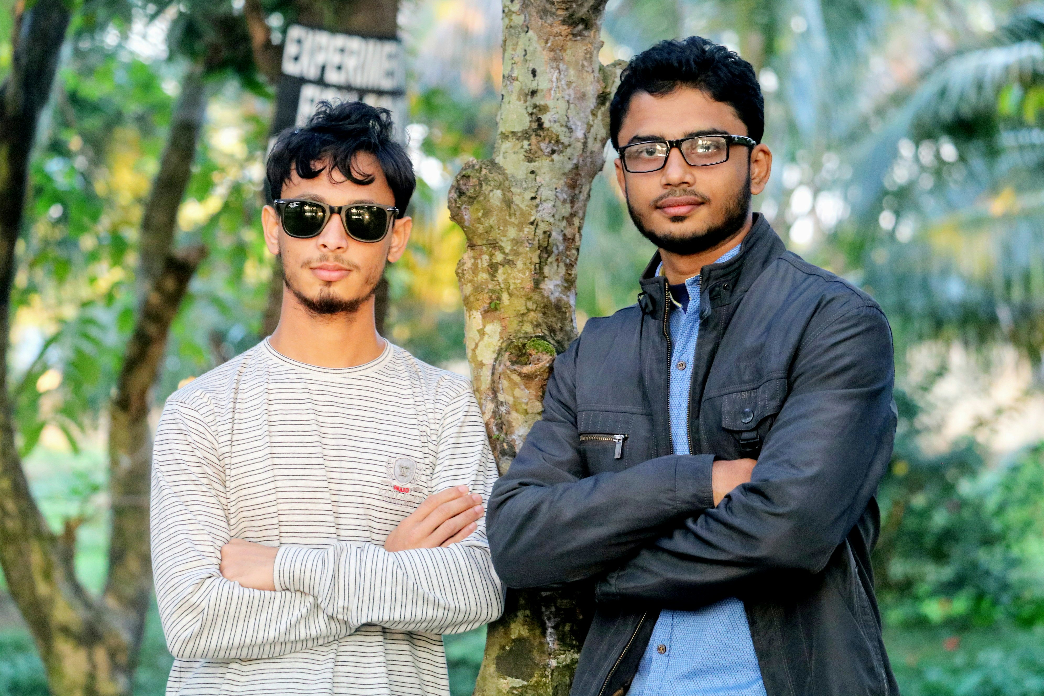 two men standing side by side both hands crossed
