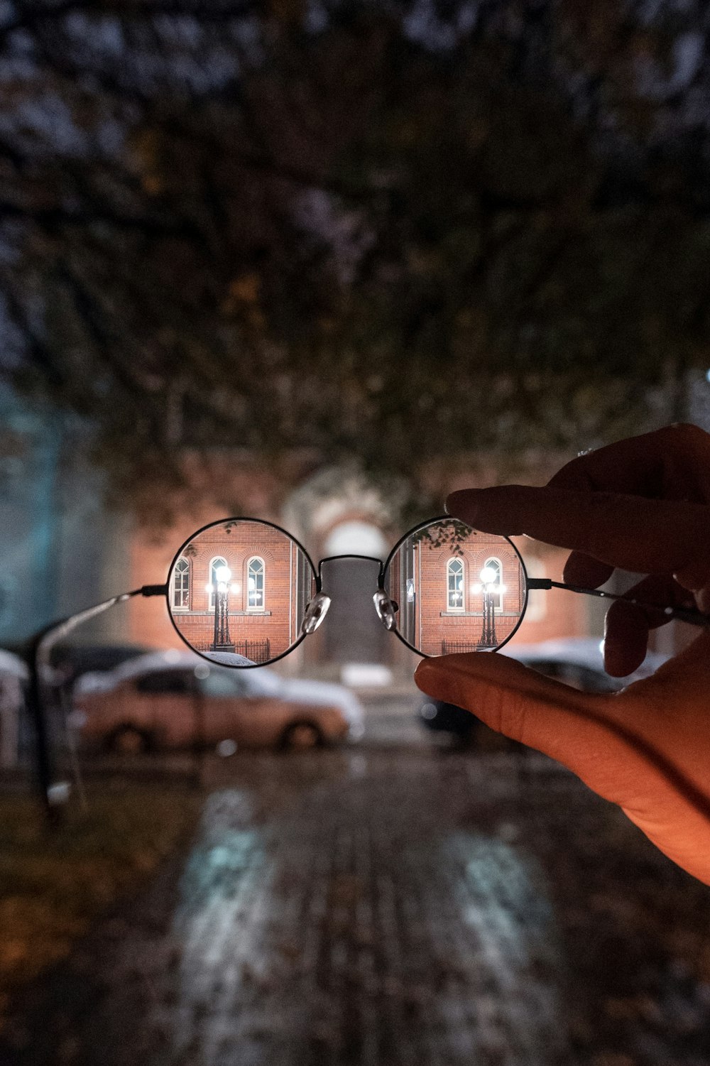 person holding black framed eyeglasses