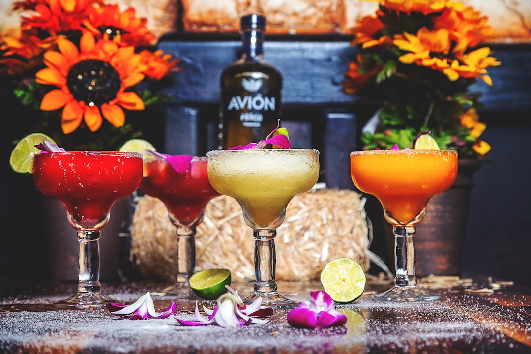 full footed glasses near flowers,
