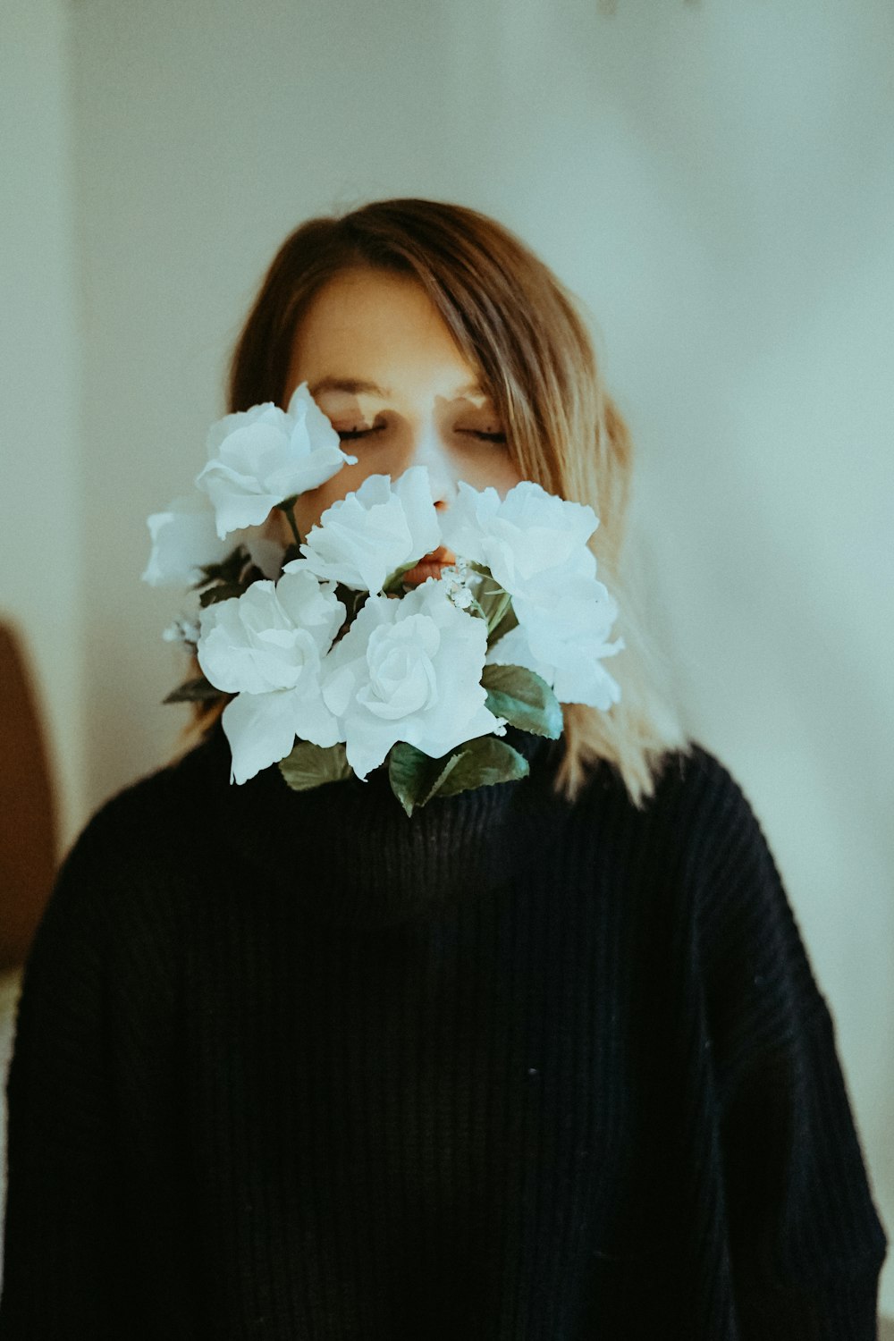 woman biting flowers