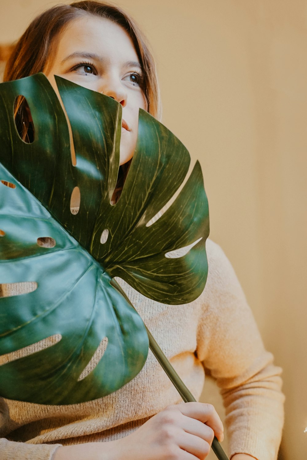 woman holding leaf