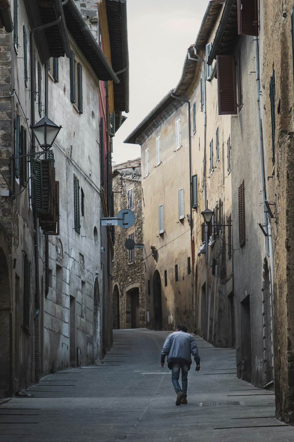 person walking on alley road during daytime