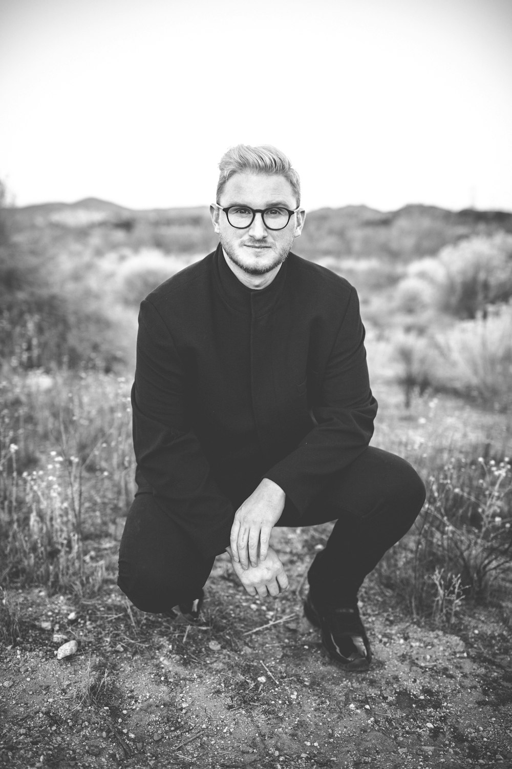 man in suit kneeling