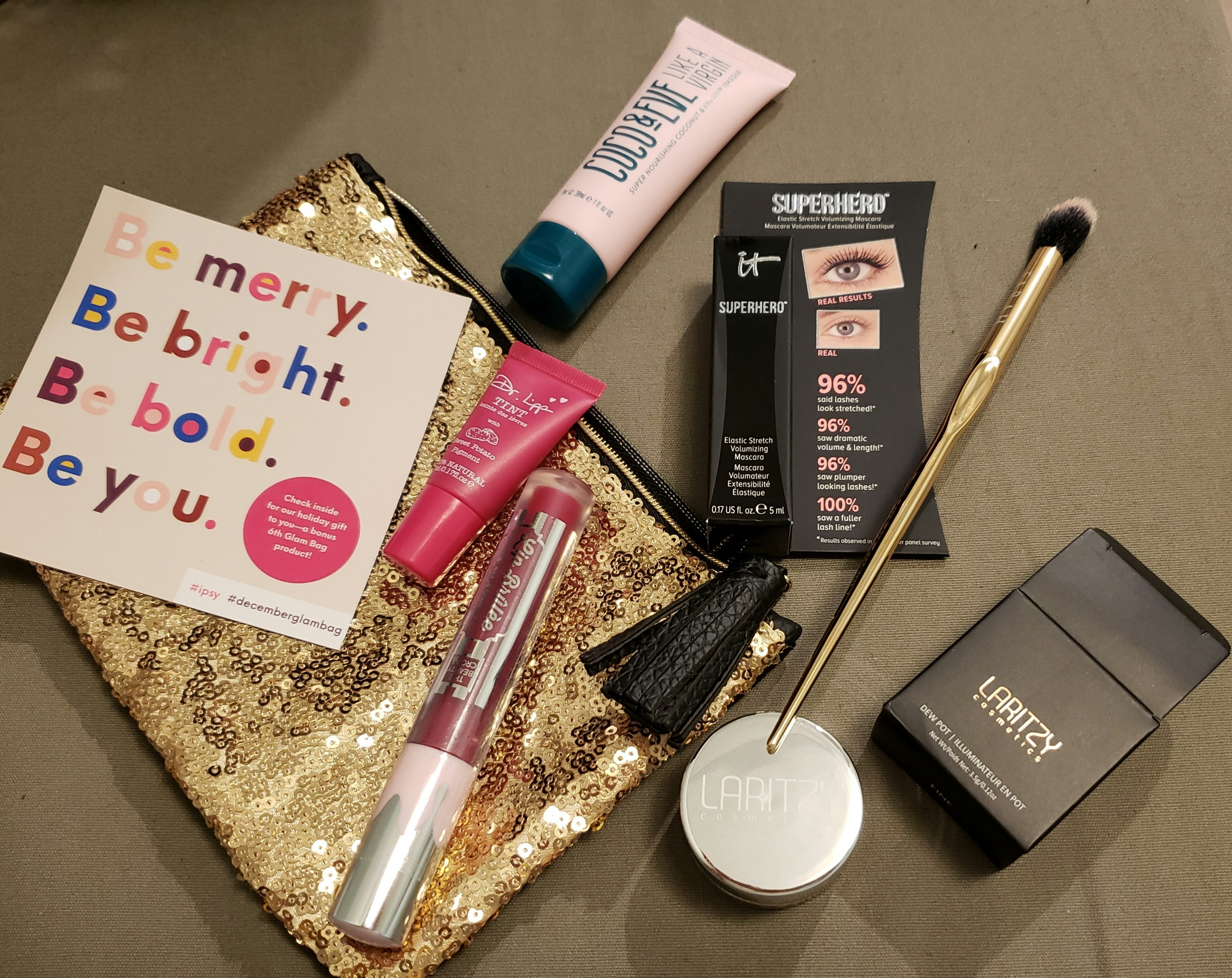 Ajan luxury makeup products flatlay with warm bronze and gold tones