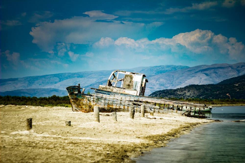 wrecked gray ship on shore